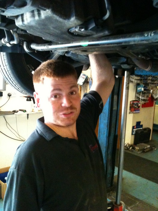 mechanic checking brakes